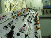 This picture shows the control area for this first production application. Complete manual controls were provided in addition to the computer control to ease maintenance and assist production. Functions were color coded to speed the training time for new operators.